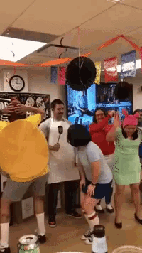a group of people dressed in costumes are dancing