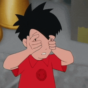 a boy in a red shirt with a smiley face on it covering his eyes