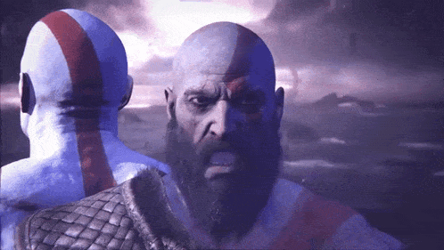 a bald man with a beard is standing in front of another bald man