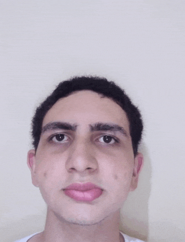 a young man with a white shirt on looks at the camera