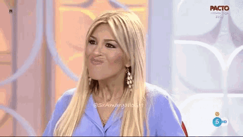 a woman in a blue shirt is talking on a tv show