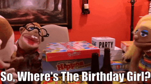 a puppet is sitting at a table with a box that says ' party ' on it