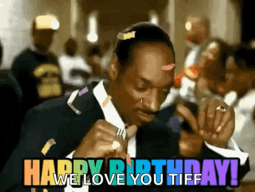 snoop dogg is wearing a suit and tie and smoking a cigarette while saying happy birthday we love you tiff .