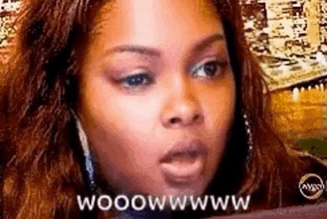 a close up of a woman 's face with the words `` woowwwwww '' written on it