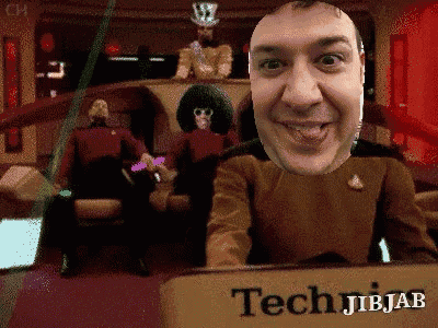 a man in a star trek uniform is smiling in front of a sign that says techjibjab
