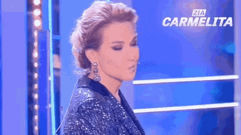 a woman in a sequined dress is standing in front of a blue background with the words carmelita on it