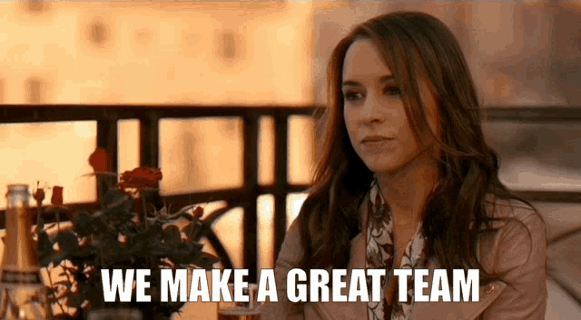 a woman sitting at a table with the words we make a great team written below her