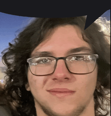a close up of a man 's face with glasses