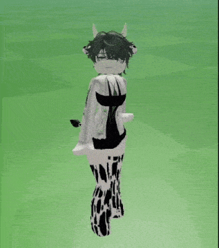 a girl in a cow costume is standing in front of a green field .