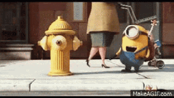 a couple of minions standing next to a yellow fire hydrant .