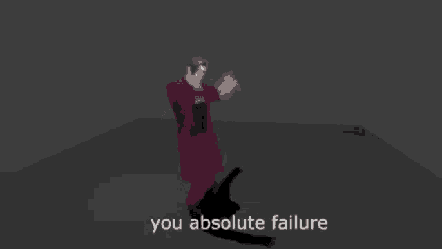 a man in a red suit is dancing with the words `` you absolute failure '' .