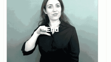 a woman is making a sign that says end