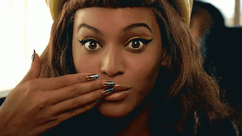 a close up of a woman 's face with her hand on her mouth