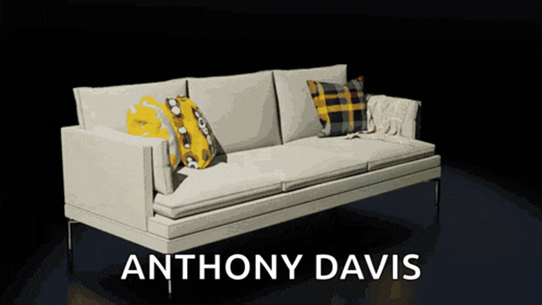 a white couch with yellow and black pillows and the name anthony davis