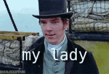 a man wearing a top hat says my lady in white letters