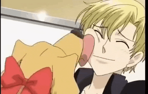 a cartoon boy is licking a stuffed animal .