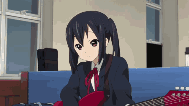 a girl with pigtails is holding a guitar