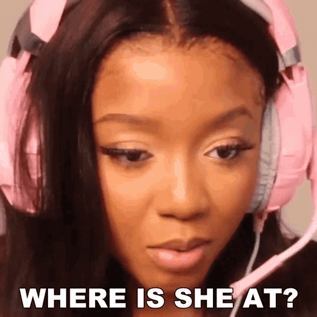 a woman wearing pink headphones says where is she at