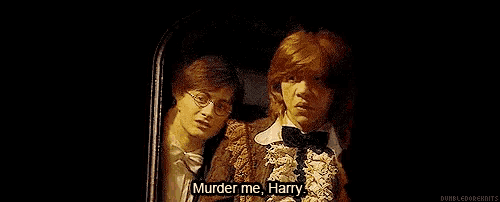 harry potter and ron weasley are standing next to each other .