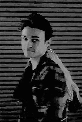 a black and white photo of a man holding a sword