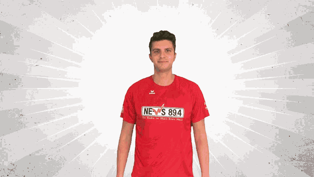 a man in a red shirt that says news 894