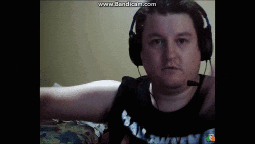a man is wearing headphones and a shirt that says ' has money ' on it