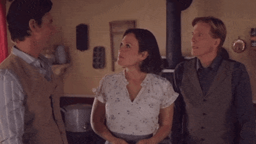 a man and a woman are laughing together in a room