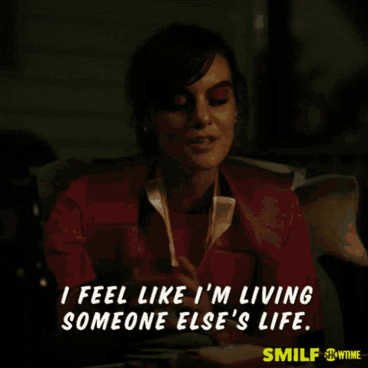 a woman is sitting in a chair with a caption that says i feel like i 'm living someone else