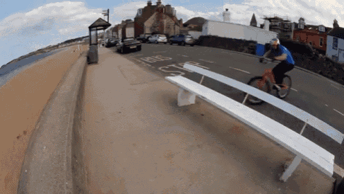 a person is riding a bike on a seesaw with the word bus on the side of the road