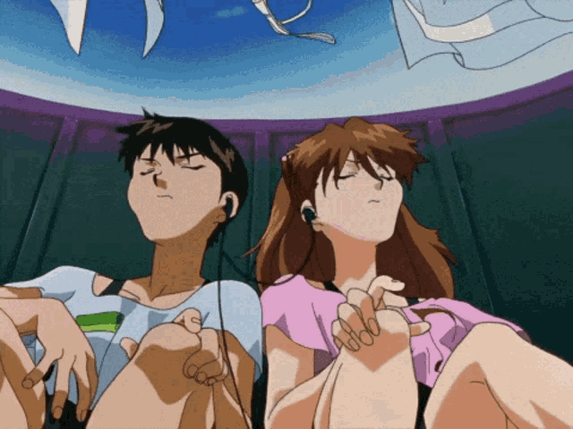a boy and a girl are sitting next to each other with headphones on
