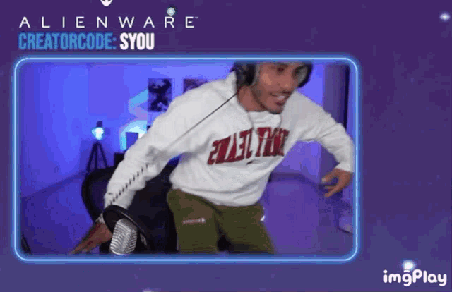 a man wearing headphones and a white shirt that says alienware