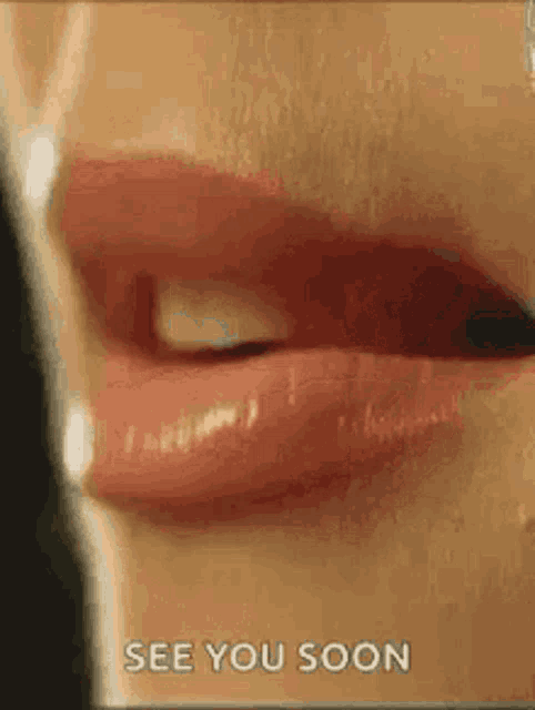 a close up of a woman 's lips with the words `` see you soon '' written on the bottom .