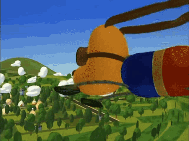 a cartoon character is flying over a lush green field