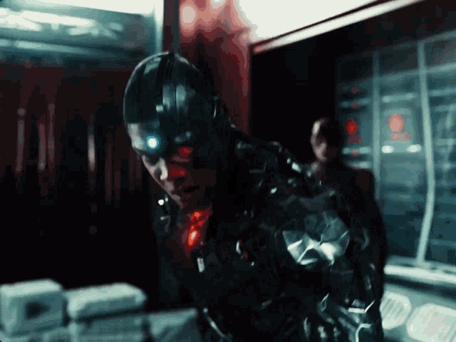 a man in a cyborg suit with a red light on his eyes