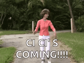 an older woman is walking down a path with the words `` ci ci 's coming !!! '' written on it .
