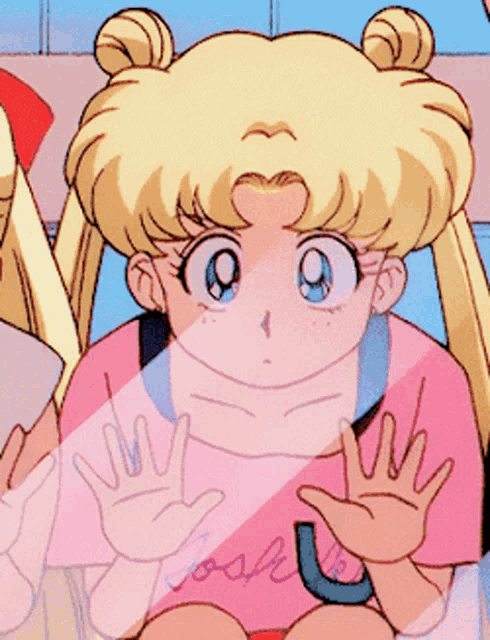 a girl with pigtails and a pink shirt has her arms crossed and her mouth open