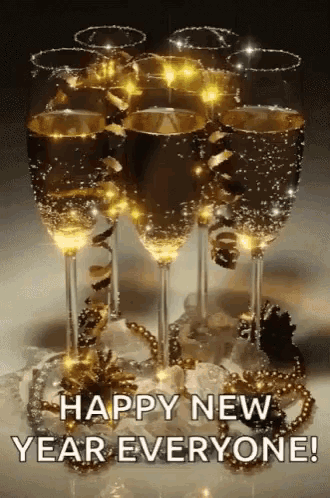 a stack of champagne glasses with the words happy new year everyone