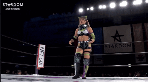 a woman in a wrestling ring with a sign that says nft lab in front of her