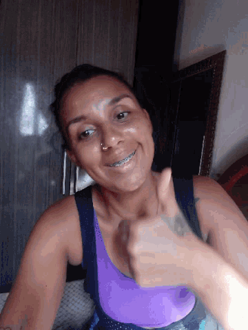 a woman with braces on her teeth is smiling