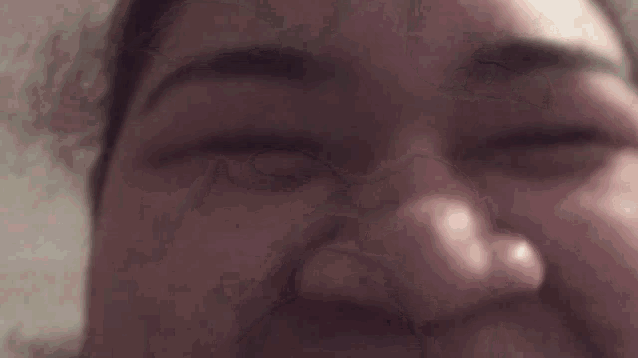a close up of a woman 's face with her eyes closed and her nose visible .