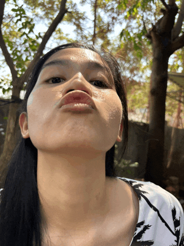 a woman is making a funny face with her mouth open