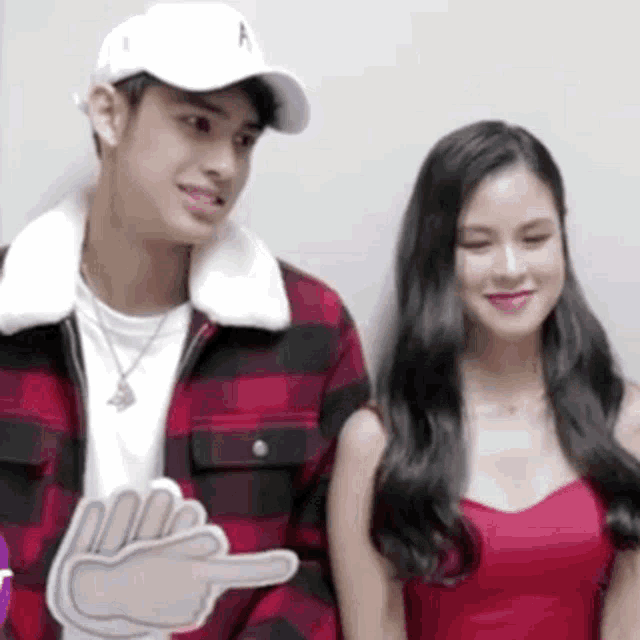 a man and a woman are standing next to each other .