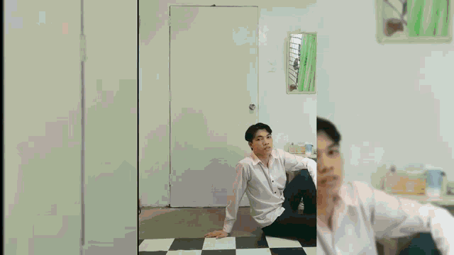 a man is sitting on a checkered floor in front of a group of young men
