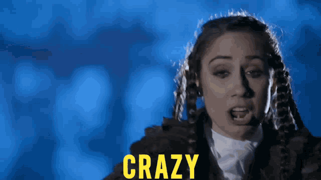a woman is screaming with the word crazy in yellow letters