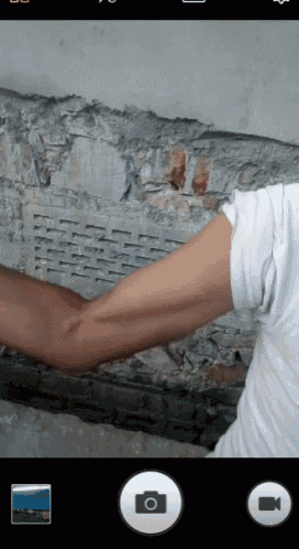 a person 's arm is being photographed with a camera app