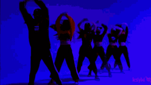 a group of people are dancing in a purple background