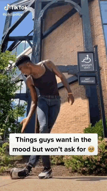 a man is doing a trick on a skateboard in front of a handicap sign .