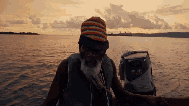 a man in a boat with a cooler that says vacation