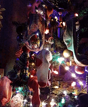 a christmas tree with a pair of socks hanging from the top