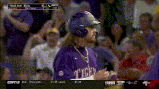 a baseball player wearing a purple jersey that says tiger